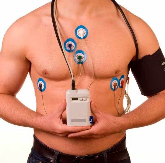 Man wearing MAPA device with electrodes and blood pressure cuff for ambulatory monitoring
