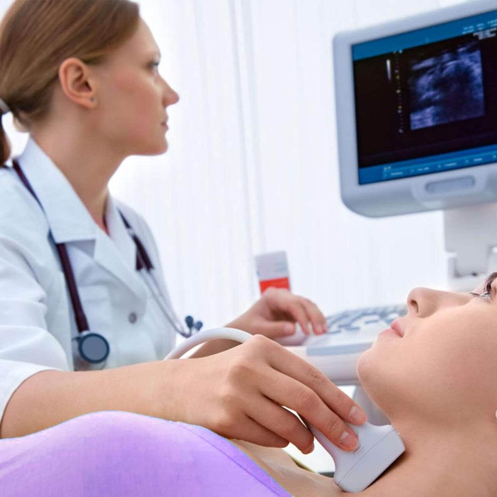 Doctor performing ultrasonido doppler carotideo to examine blood flow in carotid arteries of patient